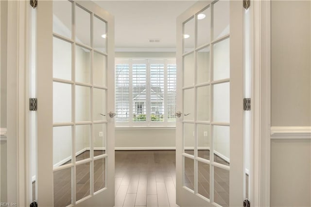 spacious closet featuring french doors and hardwood / wood-style flooring