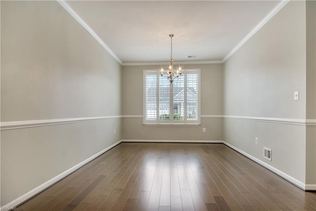 empty room with dark hardwood / wood-style flooring, crown molding, and a chandelier