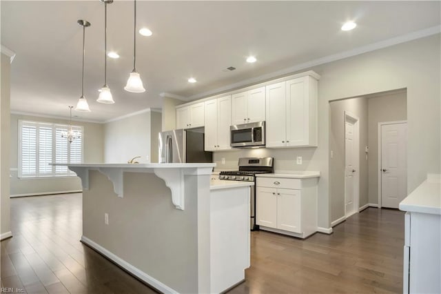 kitchen with a center island with sink, white cabinetry, hanging light fixtures, ornamental molding, and stainless steel appliances