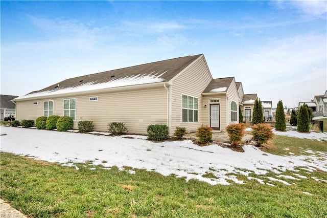 view of snow covered exterior featuring a yard