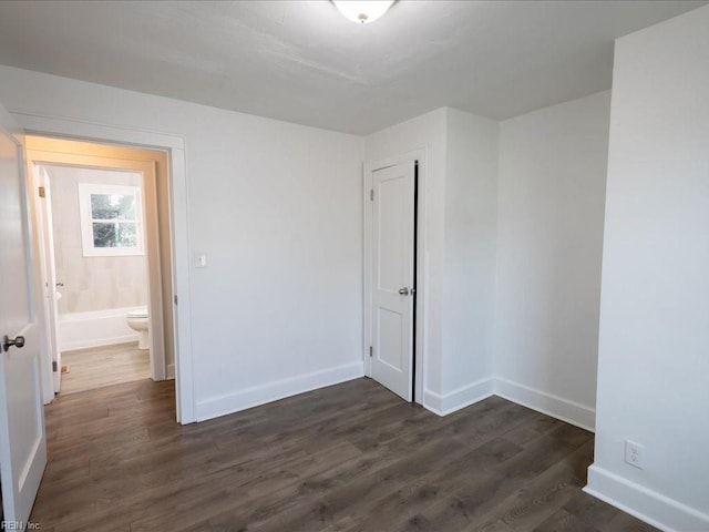 empty room with dark wood-type flooring