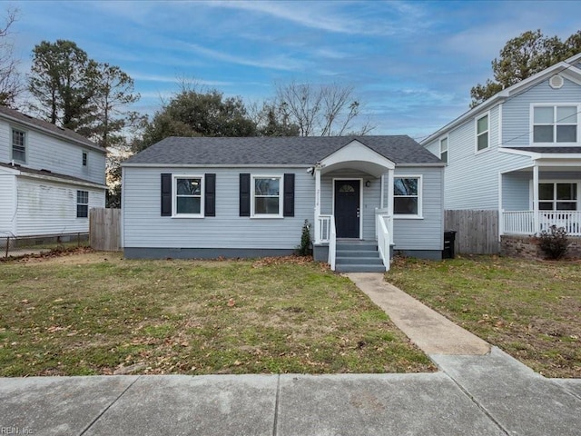 bungalow-style house featuring a front lawn