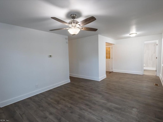 spare room featuring dark wood-type flooring and ceiling fan