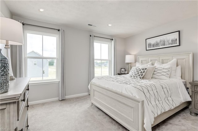 bedroom featuring baseboards, recessed lighting, visible vents, and light colored carpet