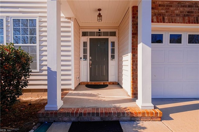 property entrance with a porch and a garage