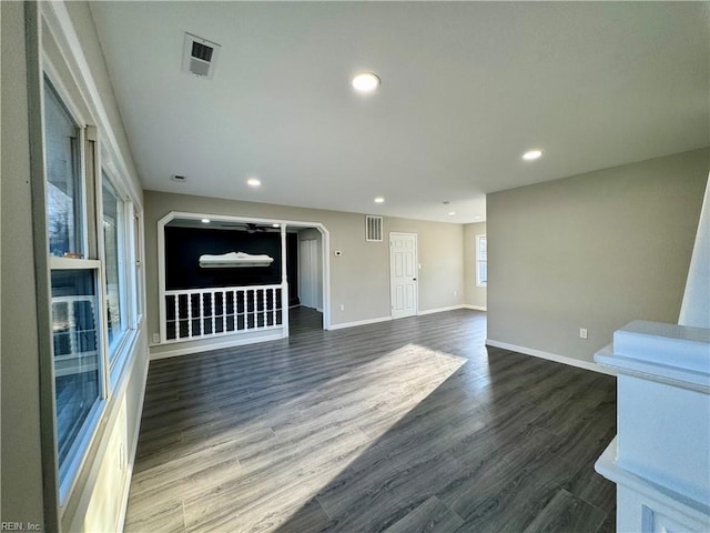 unfurnished living room with dark wood-type flooring