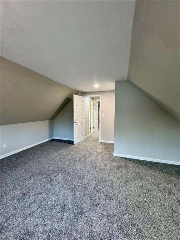 bonus room with carpet, a textured ceiling, and vaulted ceiling