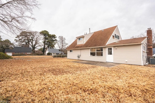 back of property with a patio