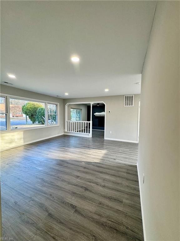 unfurnished living room with dark wood-type flooring