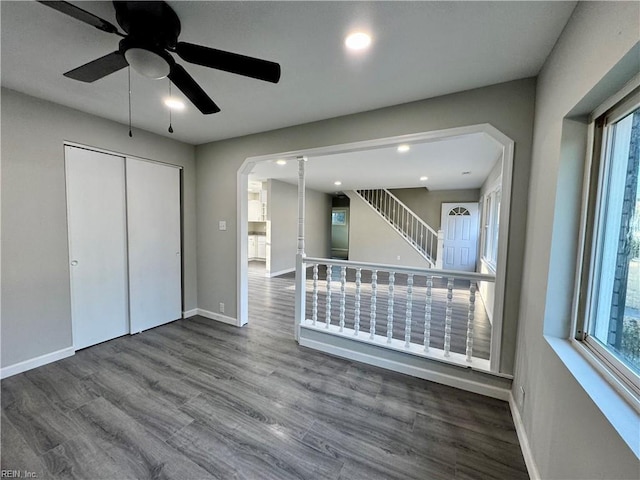 unfurnished bedroom featuring hardwood / wood-style flooring, a closet, and ceiling fan