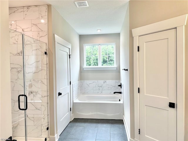 bathroom featuring separate shower and tub and tile patterned flooring