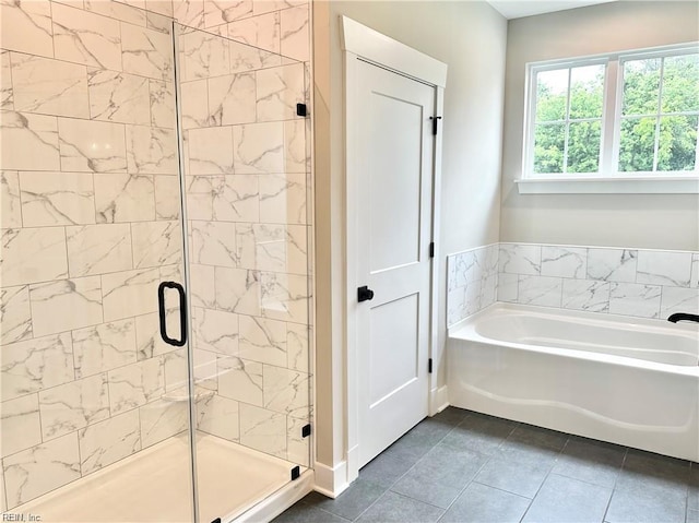 bathroom with tile patterned floors and independent shower and bath