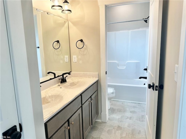 full bathroom with toilet, vanity, and washtub / shower combination