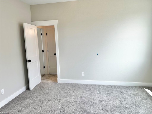 spare room featuring light colored carpet