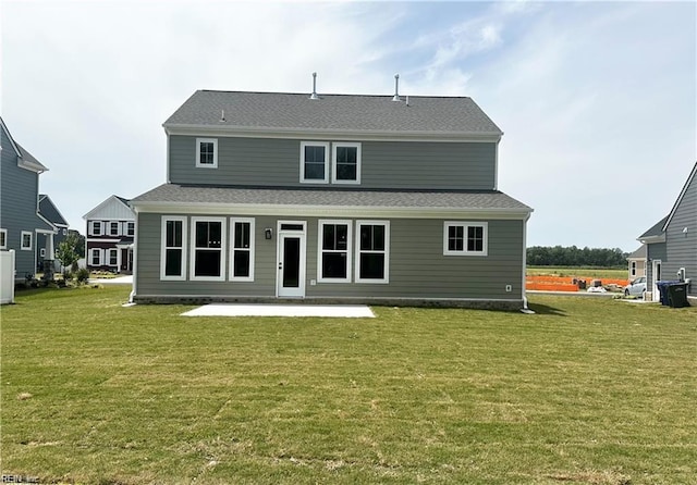 back of property featuring a lawn and a patio area