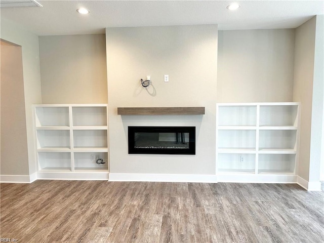 unfurnished living room with hardwood / wood-style floors