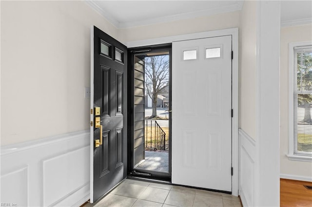 tiled entryway featuring ornamental molding