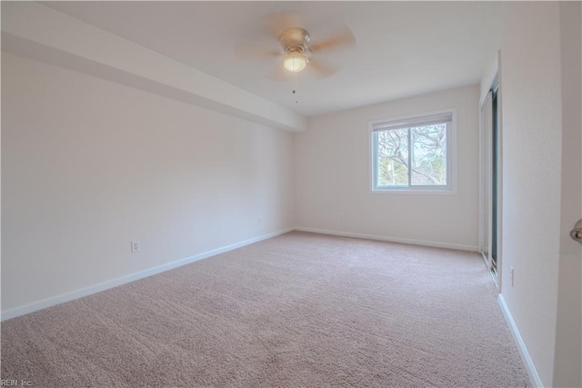 carpeted empty room with ceiling fan