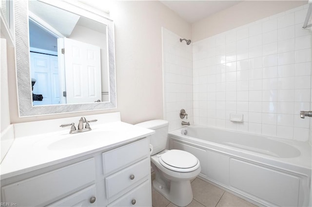 full bathroom with tiled shower / bath combo, vanity, toilet, and tile patterned flooring