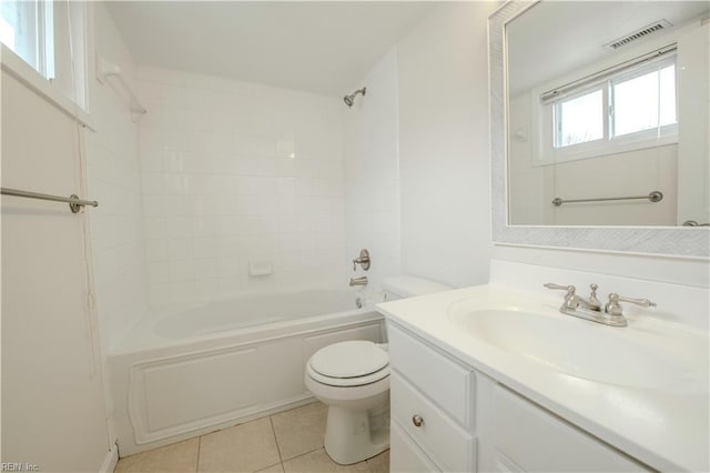 full bathroom featuring toilet, tiled shower / bath, vanity, and tile patterned floors