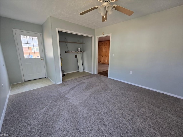 unfurnished bedroom featuring ceiling fan, a closet, and carpet floors