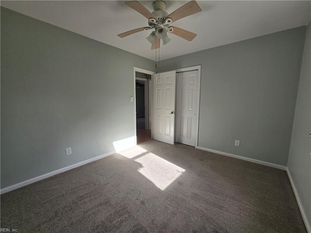 unfurnished bedroom featuring ceiling fan, a closet, and carpet