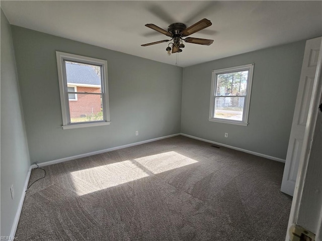 carpeted empty room featuring ceiling fan