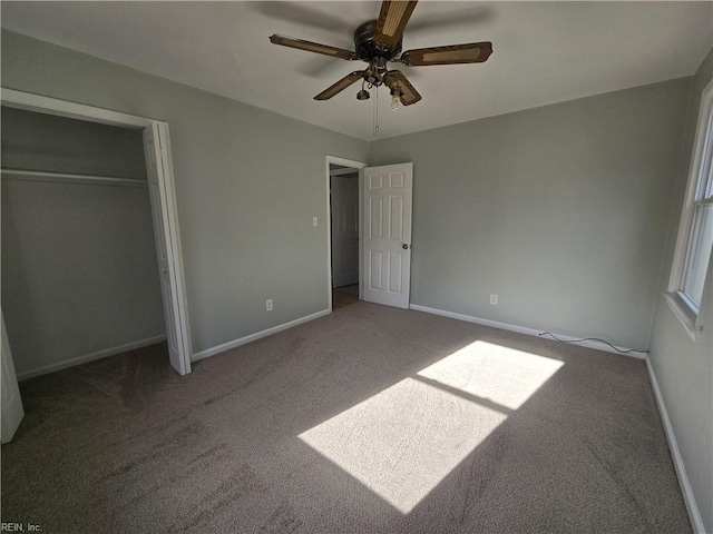 unfurnished bedroom with ceiling fan, carpet, and a closet