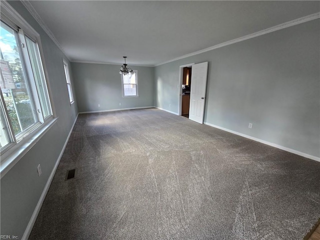 carpeted empty room featuring an inviting chandelier and crown molding