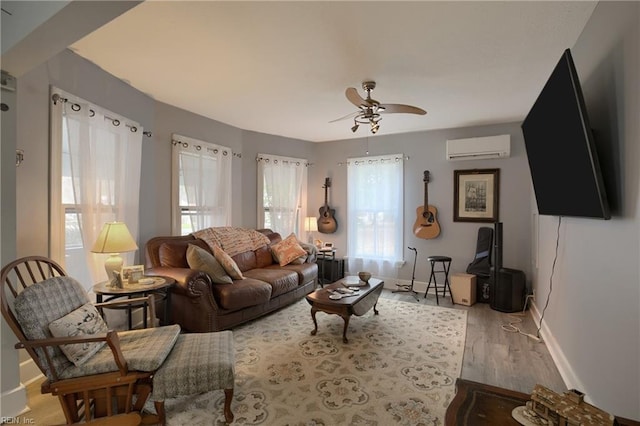 living room featuring ceiling fan, a wall mounted AC, and hardwood / wood-style floors