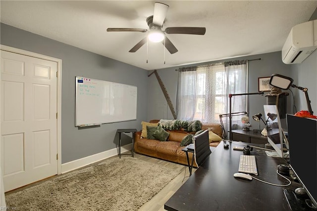 office area with a wall unit AC, ceiling fan, and wood-type flooring