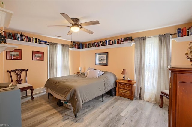 bedroom with ceiling fan and light wood-type flooring