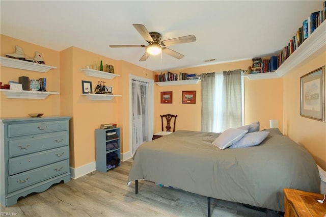 bedroom with ceiling fan and light hardwood / wood-style floors