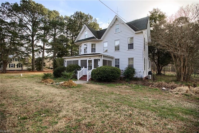 view of front of property with a front lawn and a sunroom