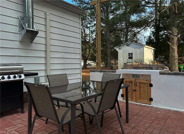 view of patio featuring a grill and a storage unit