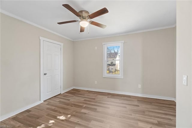 unfurnished room with ceiling fan, light wood-type flooring, and crown molding