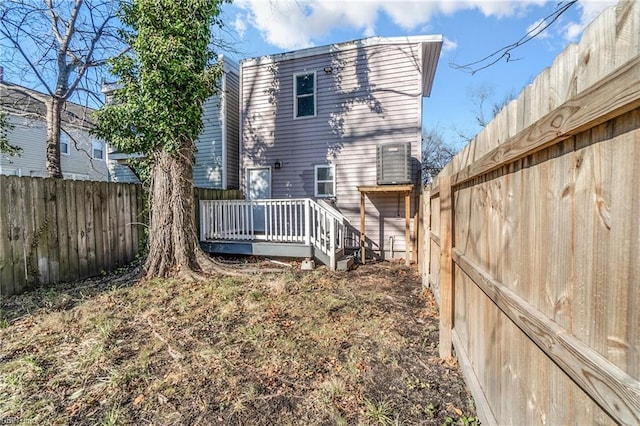 rear view of property featuring a deck