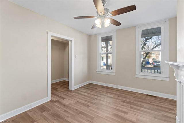 empty room with ceiling fan and light wood-type flooring