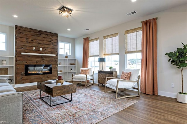 living room featuring a fireplace and wood-type flooring