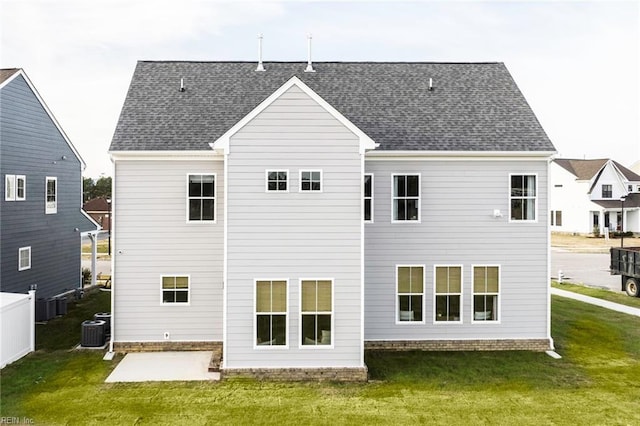 back of house with a lawn, central air condition unit, and a patio area