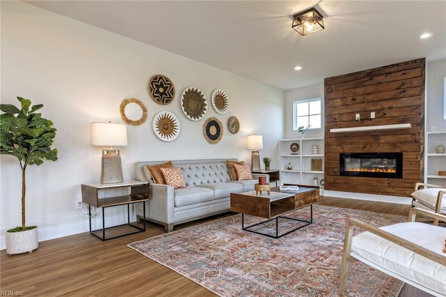 living room featuring a large fireplace and hardwood / wood-style flooring