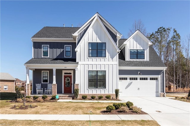 view of front of house featuring a front lawn, a garage, and a porch