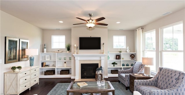 living room featuring ceiling fan, plenty of natural light, and dark hardwood / wood-style floors