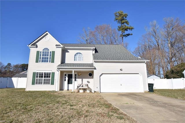 view of property featuring a front lawn, a garage, and covered porch