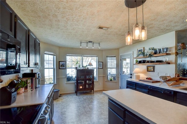 kitchen with a textured ceiling, pendant lighting, and black appliances