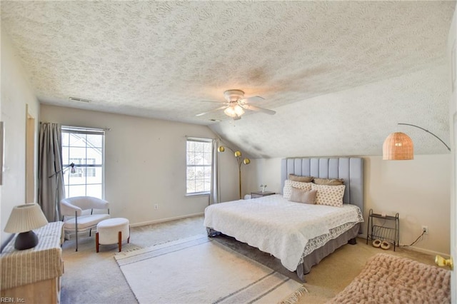 bedroom with lofted ceiling, light colored carpet, ceiling fan, and a textured ceiling