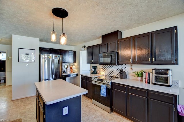 kitchen with appliances with stainless steel finishes, hanging light fixtures, a textured ceiling, dark brown cabinetry, and a center island