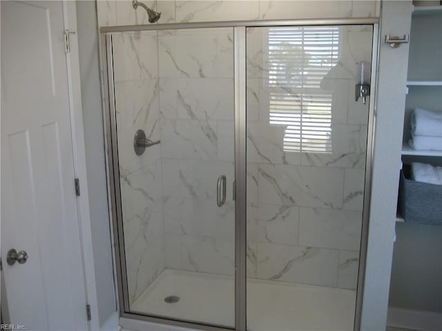 bathroom with a shower with shower door