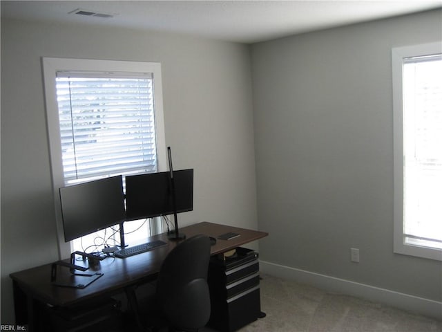 office area featuring plenty of natural light and carpet flooring