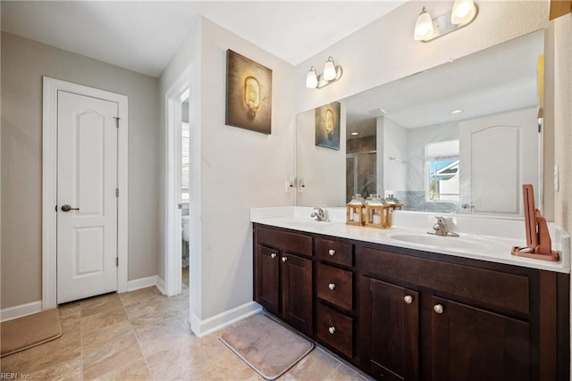 bathroom with vanity, toilet, and a shower with door